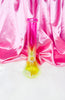 Back view of the neon pink and yellow bong with a diamond base