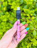 Cute pink cowgirl weed pen battery on green background