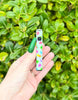 Good luck charm vape pen on green background