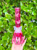 Pink 10" butterfly beaker bong on green backgrond
