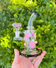 Pink glow in the dark ghosts bong on green background