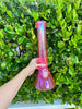 Pink 16 inch iridescent bong in natural lighting outside to shows its beautiful color