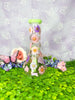 Beautiful green dried floral bong with pink and purple flowers  with a purple background.