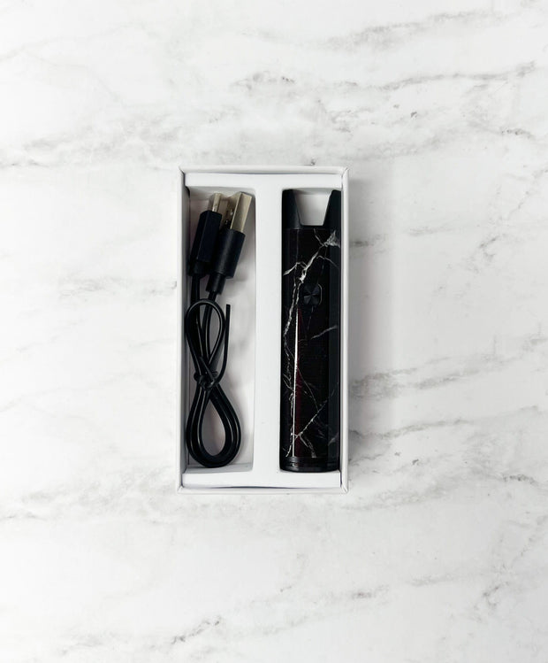 Black and grey marble stiiizy pro battery in box with usb-c charger on white background