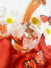 Close up of the amber iridescent butterfly dab rig showing its iridescent butterfly charms