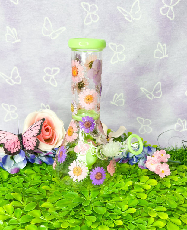 Green dried floral bong with pink and purple flowers.