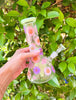 Super cute green dried floral bong side view showing its purple and pink floral design