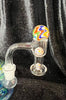 Rainbow terp slurp 14mm set close up on black backround includes two marbles and a pill