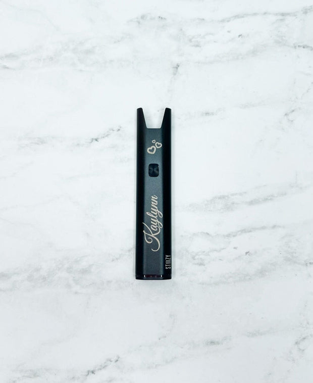 Stiiizy pro battery on white background showing its custom engraving and icons