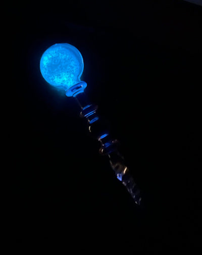 Pink glow in the dark dab tool in the dark showing it illuminating